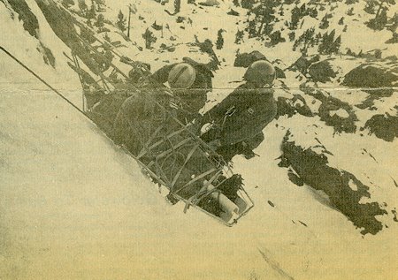 After being given first aid, the 'injured' climber is lowered down the slope in a liter by rescuers