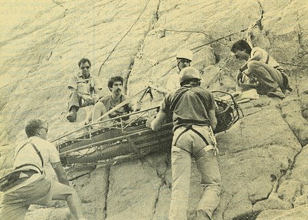 Rescuers carefully lower Galen Okazaki of Woodland Hills down from a ledge on Iris Rock last Friday