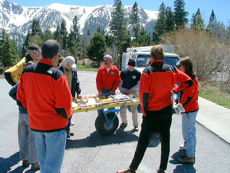 Bill Greene demonstrates wheeled litter handling to new candidates - May 11, 2002 Bill Greene demonstrates wheeled litter handling to new candidates - May 11, 2002