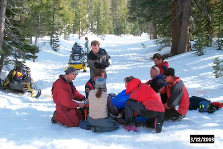 Snowmobile crash victim being treated at scene of the accident