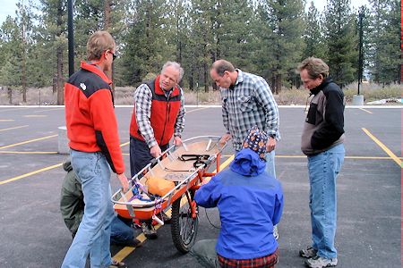 Pete and Jeff demonstrate wheeled-litter assemby to the new candidates