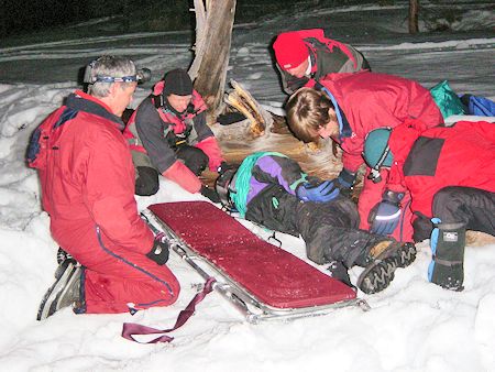 Night rescue exercise - preparing to place victim on stretcher Night rescue exercise - preparing to place victim on stretcher
