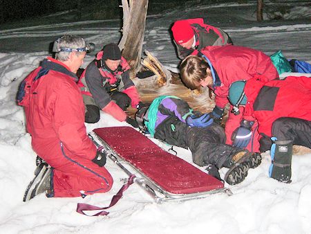 Night rescue exercise - preparing to place victim on stretcher