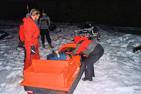 Night rescue exercise - making the victim comfortable in the sled Night rescue exercise - making the victim comfortable in the sled