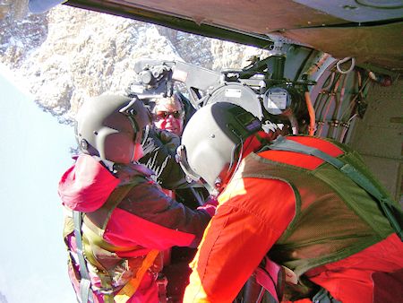 Rescuer and subject hauled up to helicopter Rescuer and subject hauled up to helicopter