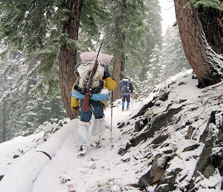 Mike Burdett and team hiking out in fresh snow