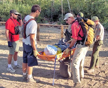 Preparing to transport subject in wheeled litter