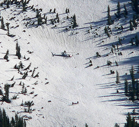 Helicopter ready to hoist victim in litter Helicopter ready to hoist victim in litter