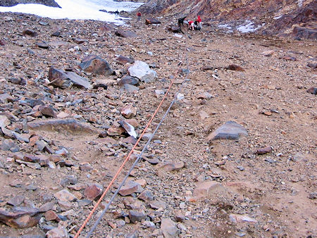 Belay line down over the bolders to the snow slope Belay line down over the bolders to the snow slope