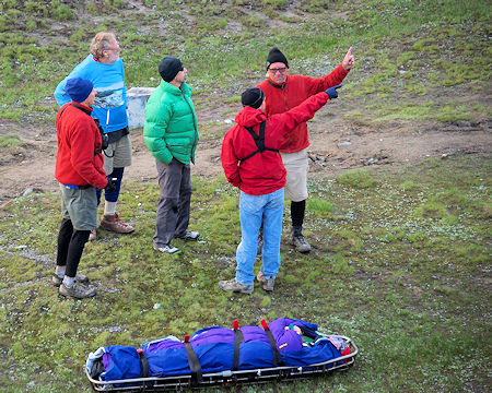 SAR members discuss the situation while the pilots prepare the helicopter SAR members discuss the situation while the pilots prepare the helicopter