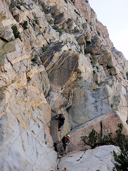 Team climbing to subject