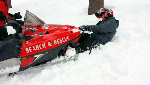 Pack the snow that the front of the machine was high centered on by kicking it down under the track