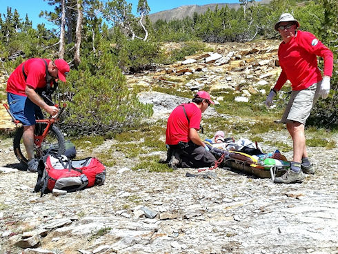 Preparing victim to be evacuated via wheeled litter