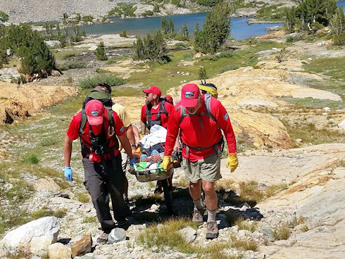 Evacuating victim via wheeled litter Evacuating victim via wheeled litter