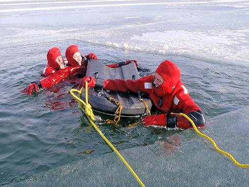 Lia and Ron using a Carlson Board to extricate Tyler from the water