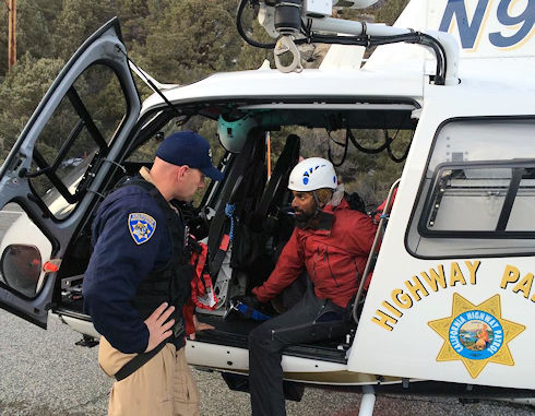 Viren Perumal discussing operation with helicopter pilot