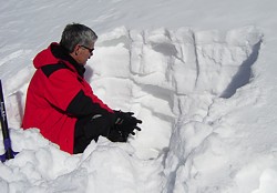 Bill Greene digging snow pit and evaluating snow Bill Greene digging snow pit and evaluating snow