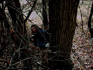 Girl hiding behind tree