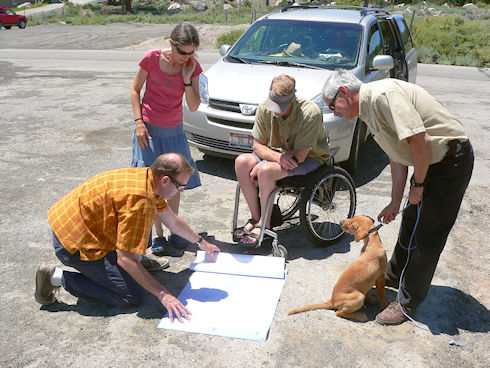 Erik Schultz examining building plans with SAR Officers